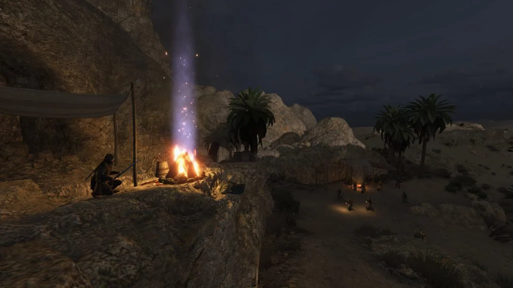 Mount & Blade 2: Bannerlord screenshot of someone crouched near a campfire with a beam of light above it