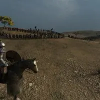 Mount & Blade 2 Bannerlord screenshot of a knight in front of a large army among the hills.